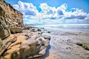 View of North Bluff Preserve cliffs and Pacific Ocean with giant rock in the foreground